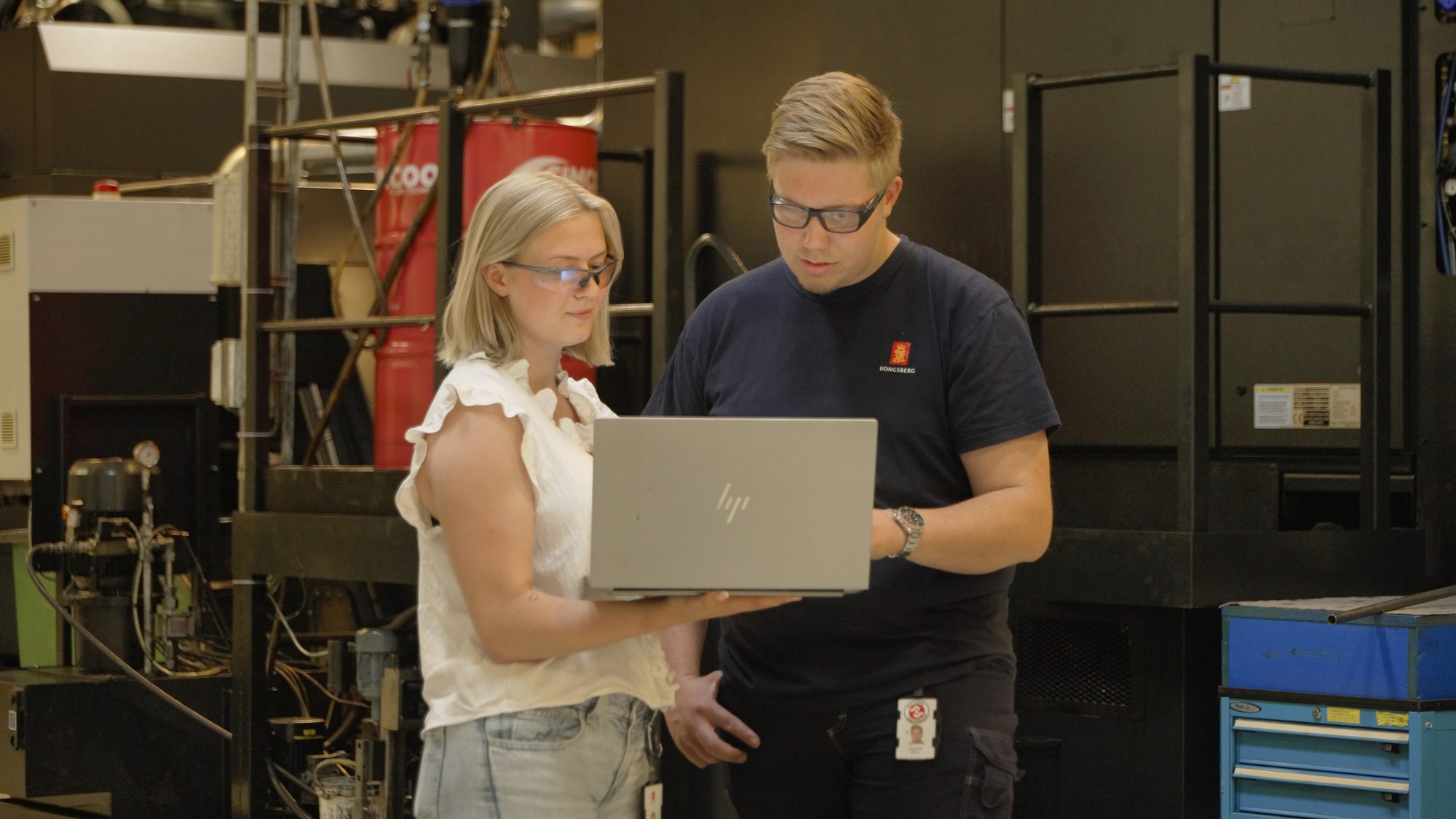Two colleagues going through a checklist on the workshop floor