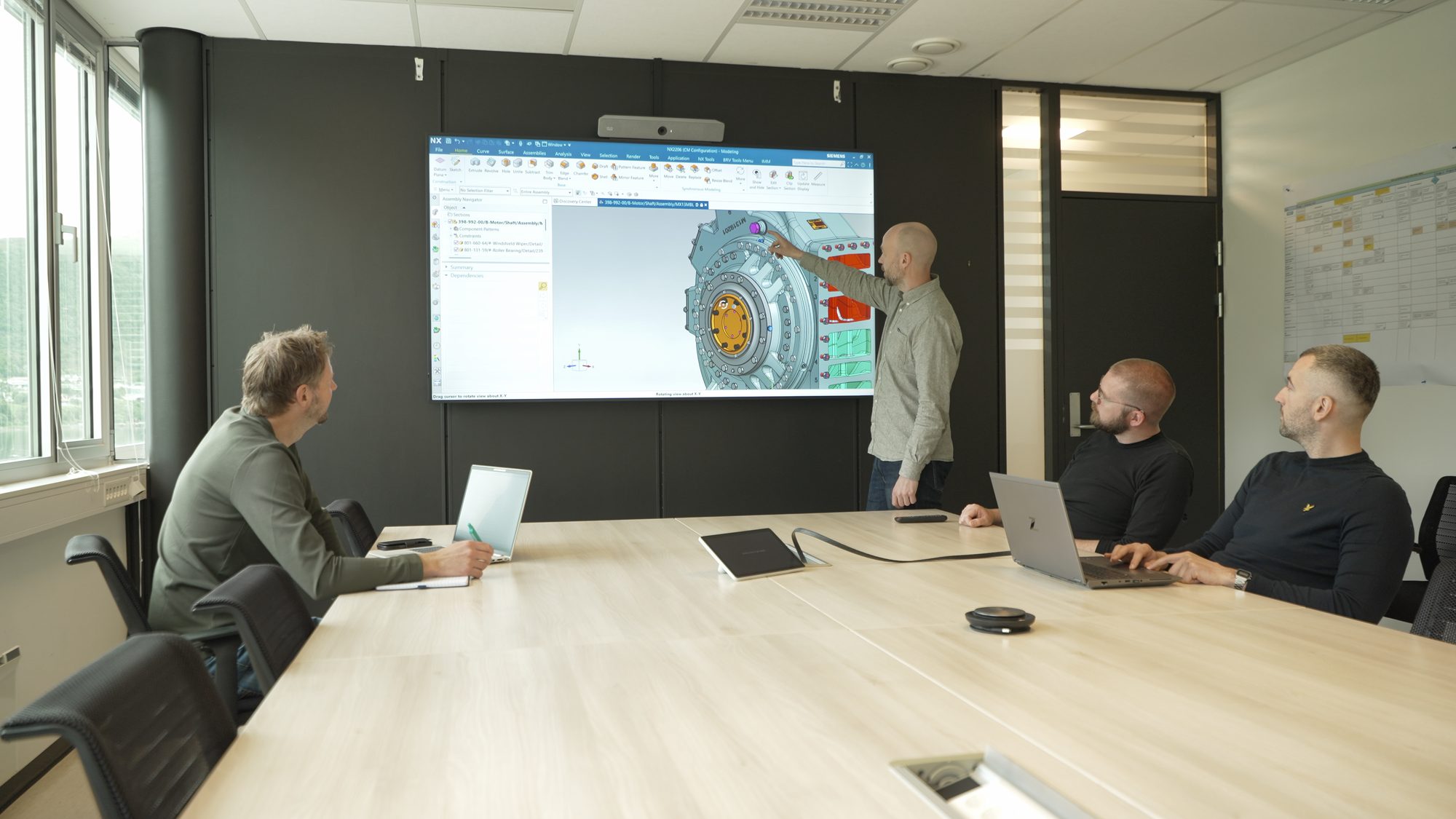 Engineers reviewing a 3D model of a winch motor