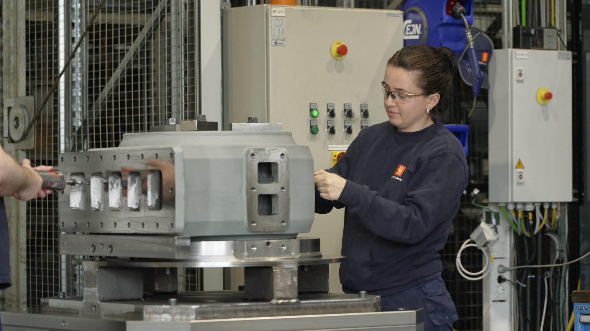 Operator preparing a machined motor housing