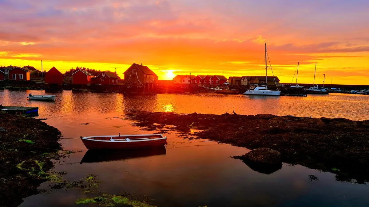 Harbour boats in a blazing orange sunset at Nordøyane