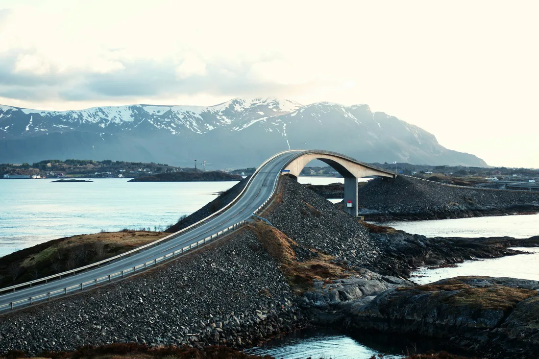 The Storseisundet bridge on Atlanterhavsveien covered in snow on a dramatic winter day