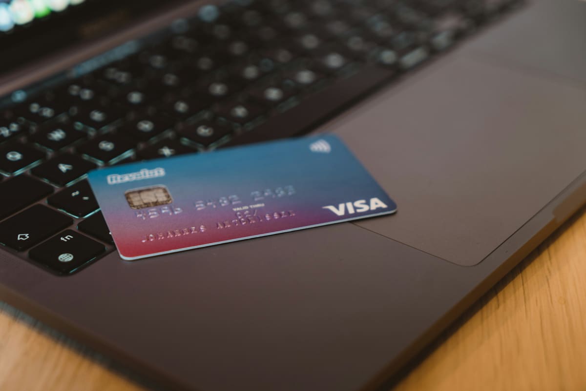 A bank card resting on a laptop keyboard, representing online banking access