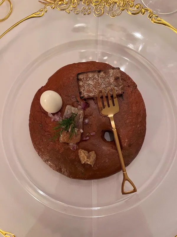 An artfully plated dish served on antique china at Oldemors Hus
