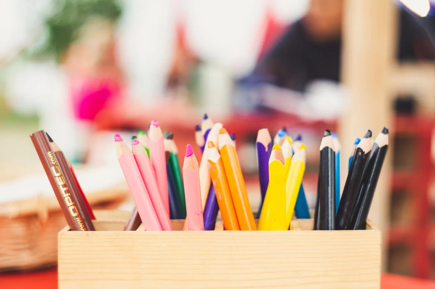 A box of colorful drawing pencils ready for use
