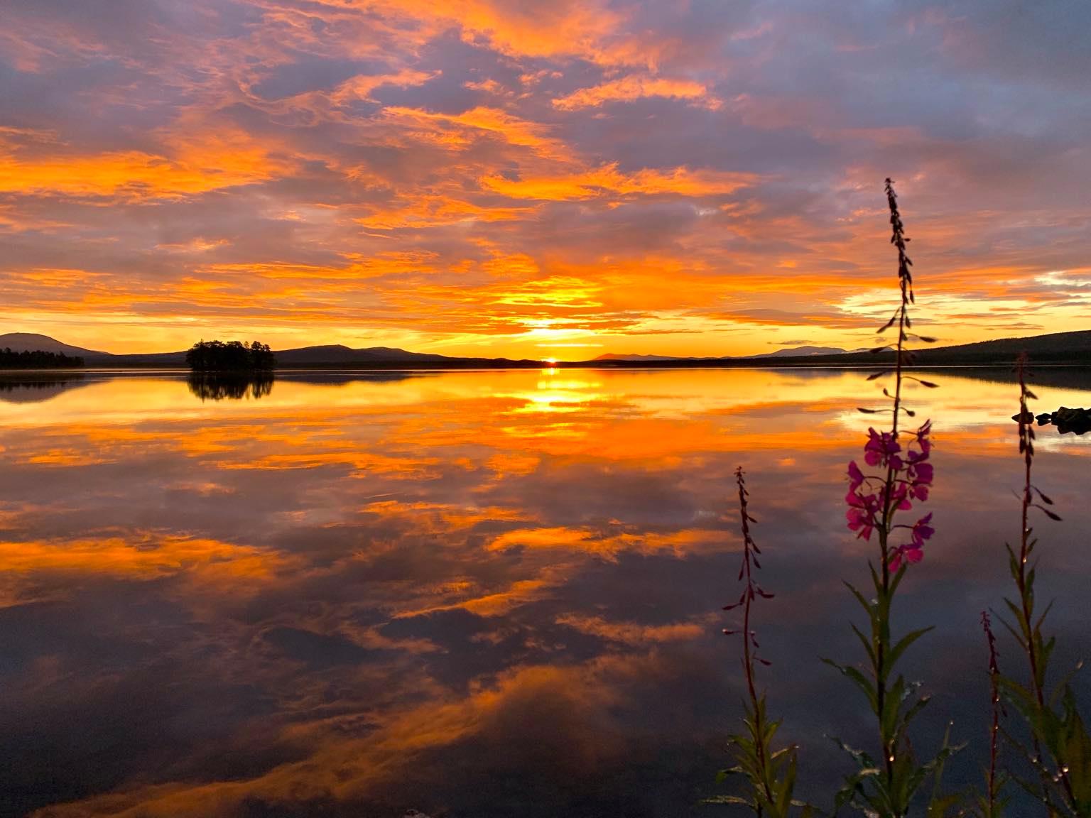 Sunrise at Sølensjøen — the lake calm, mist on the water, the village just stirring