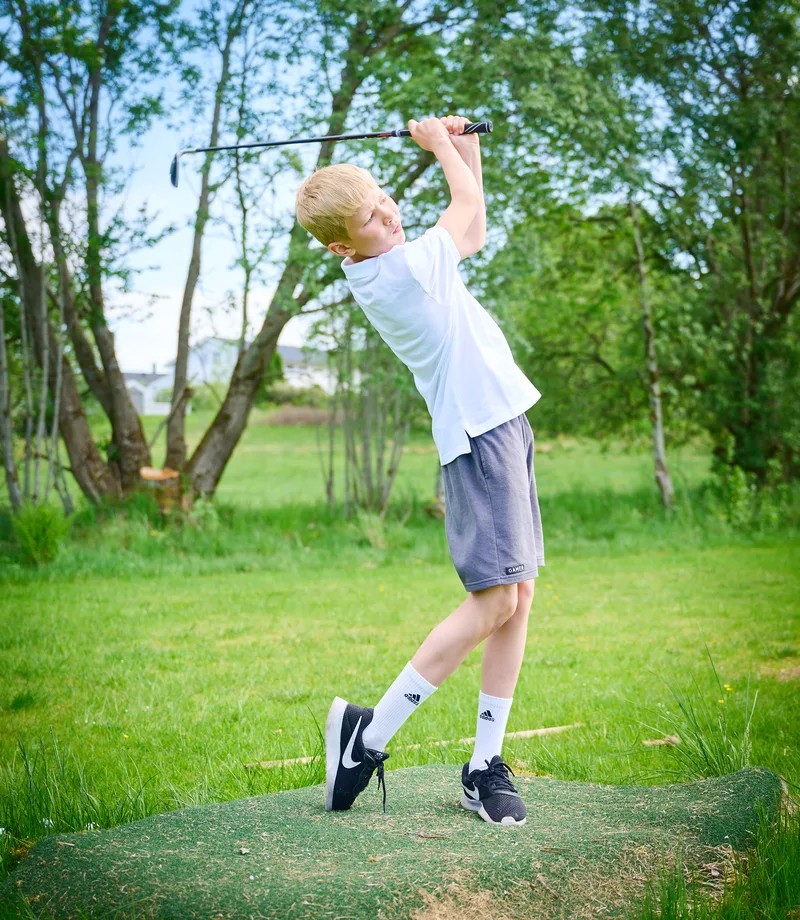 Boy playing golf in Aukra