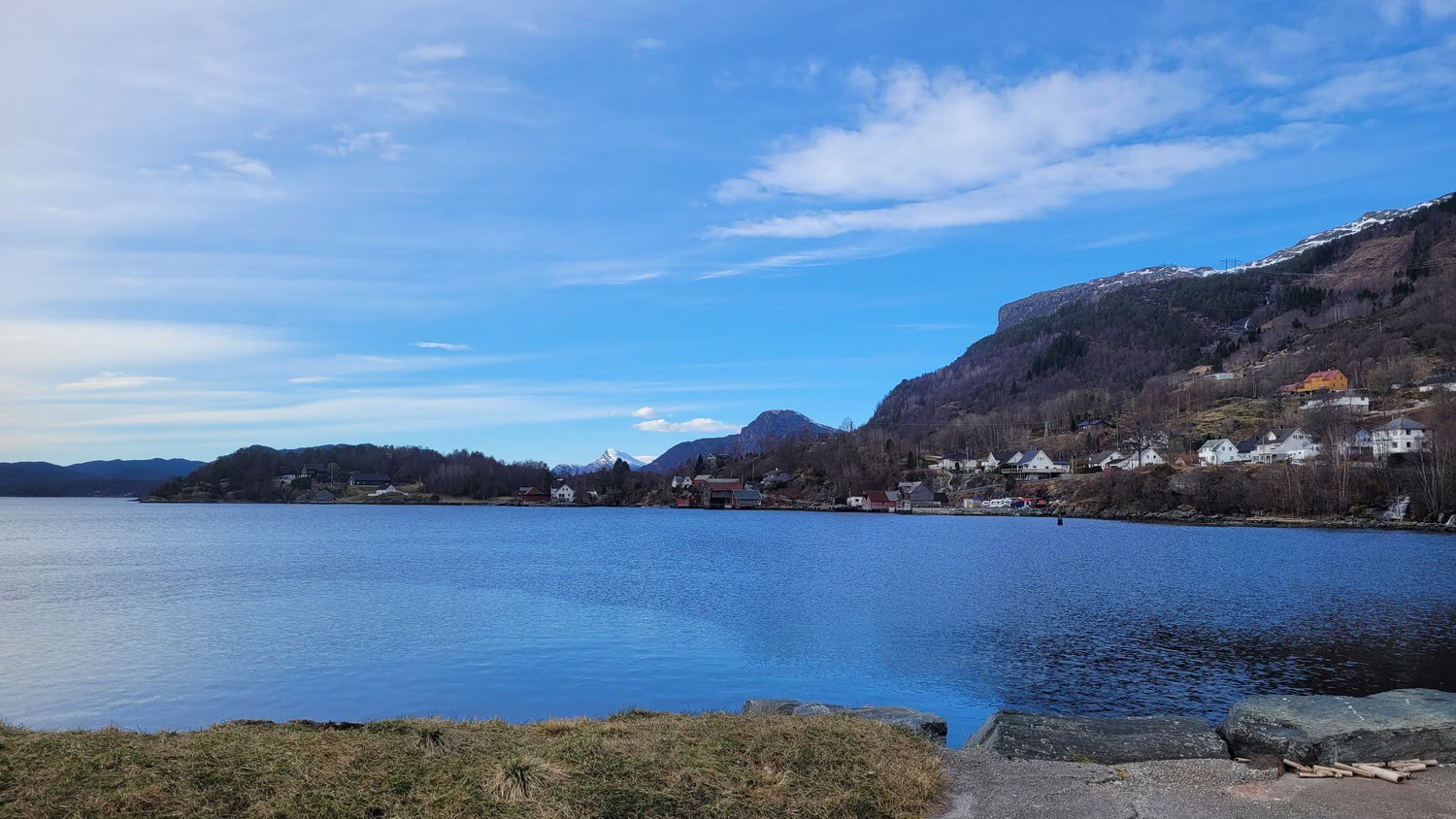 Eikefjord village by the fjord with mountains in the background
