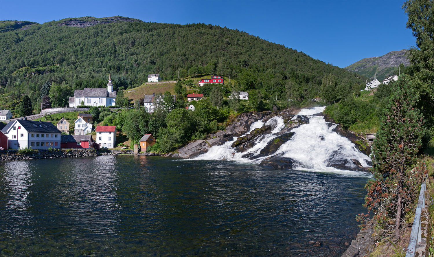 Hellesylt village at the end of Sunnylvsfjorden, surrounded by towering mountains