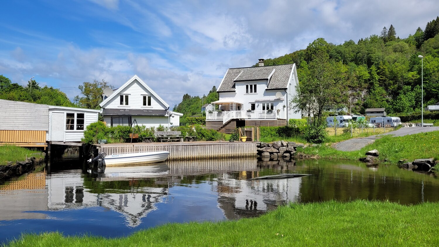 Hosanger waterfront with boathouses and mountains in the background